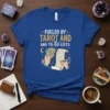 Fueled By Tarot And To-Do Lists quote on a blue t-shirt, featuring tarot cards and a checklist graphic