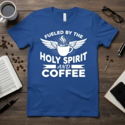 White text "Fueled by the Holy Spirit and Coffee" with winged coffee cup graphic on a blue t-shirt