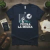 Navy t-shirt with "FUERA LA MIGRA" text and a graphic of a fist breaking chains and a bird flying, symbolizing