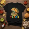 Funny monster taco graphic with colorful "TACOS" text on a black t-shirt