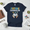 Future Counselor T-Shirt with open book, brain, and clock graphics. Navy blue tee with blue and yellow text