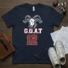 Navy t-shirt with "G.O.A.T 12" text and a graphic of a ram's head, designed for sports fans
