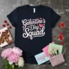Galentine's Day Squad text in white and pink script on a navy t-shirt, surrounded by pink hearts