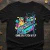 Golden retriever wearing VR goggles playing pinball with text "GAME ON, FETCH & FLIP" on a black t-shirt