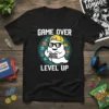 Game Over Level Up t-shirt featuring a cool ghost character playing a video game, wearing sunglasses and a yellow cap