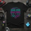 Black t-shirt with "Game Over Really Great" text in neon pink and blue, featuring game controllers and a play button