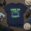 Navy t-shirt with "GAME ON IT'S MY BIRTHDAY!" text and a video game controller graphic, representing a gamer's birthday celebration