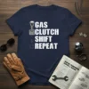 Gas Clutch Shift Repeat text design with a graphic of a manual gear shifter on a navy blue t-shirt