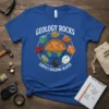 Blue t-shirt with "Geology Rocks Earth's Building Blocks" text and cartoon illustration of Earth surrounded by various rock types