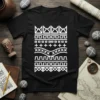 Black t-shirt with a white geometric tribal pattern featuring crowns, squares, crosses, and zigzags