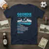 Navy blue t-shirt with "GEORDIE ACCENT TRANSLATOR" and a list of Geordie words and their meanings, featuring a bridge graphic