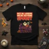 Get In, Losers We're Getting Spooky text on a black t-shirt with a retro Halloween train graphic featuring ghosts and