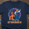 T-shirt with "Get Your Groove On" text and two cartoon cats dancing in disco outfits, vibrant neon circle background