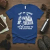 T-shirt with "GET IN LOSER WE'RE GOING TO THE COTTAGE" text and Bigfoot graphic by a log cabin, white ink