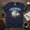 Ghost Writer T-Shirt featuring a cartoon ghost wearing glasses and a hat, typing on a laptop with a quill pen