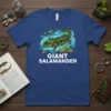 T-shirt design featuring a green and yellow spotted giant salamander swimming in water, with text "GIANT SALAMANDER" below