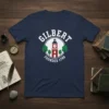 Navy blue t-shirt featuring "GILBERT FOUNDED 1789" text with a clock tower graphic and trees, representing town pride