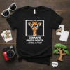 Black t-shirt with "GIRAFFE PHOTO BOOTH STRIKE A POSE!" text and a cartoon giraffe wearing sunglasses