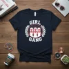 Girl Gang text with three female silhouettes in a laurel wreath on a navy t-shirt
