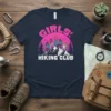 Girls Hiking Club t-shirt featuring five women celebrating on a mountain peak with pine trees and a sunset background