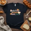 Girls Just Wanna Have Pan t-shirt with colorful lettering and pastry graphics, including croissants and hearts