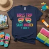 Girls Trip Saint Marten 2026 text with aviator sunglasses graphic showing palm trees and sunset