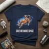 Astronaut floating in space with "Give Me More Space" text on a navy t-shirt