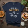 Navy t-shirt with white and orange text that reads "GIVE ME WAFFLES AND TELL ME I'M Pretty"