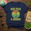 Retro t-shirt with green text "GIVE PEAS A CHANCE" above a peace sign containing a pea pod with smiling peas