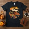 Give Thanks to the Lord Thanksgiving T-Shirt with cornucopia, sun, and autumn leaves. Psalm 107:1 scripture