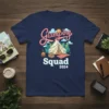 Glamping Squad 2024 text with a cartoon tent, campfire, and trees on a navy blue t-shirt