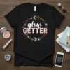 Glow Getter quote t-shirt design with celestial wreath and pink text on a black shirt