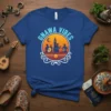 Gnawa Vibes t-shirt design featuring silhouettes of musicians playing traditional instruments against a sunset and mosque graphic