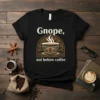 Black t-shirt with white text "Gnope, not before coffee" and a graphic of a steaming coffee cup