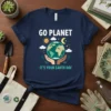 Go Planet It's Your Earth Day t-shirt design featuring hands holding the Earth, sun, moon, and clouds