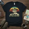 T-shirt with "Go Your Own Way" text and vintage RV camping graphic, featuring mountains, trees, and a sunset
