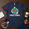 Navy blue t-shirt with "Gobble Gobble" text and a cartoon turkey nurse graphic