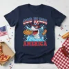 God Bless America t-shirt design with a shark wearing a patriotic hat and holding pizza and a hot dog
