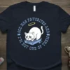 T-shirt with text "God Has Favorites And I'm Not One Of Them" featuring a sad cartoon cat in a litter