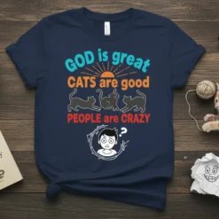 T-shirt with "GOD is great CATS are good PEOPLE are CRAZY" text, featuring three black cats and a distressed person