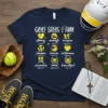 Navy t-shirt with "God Says I Am" and affirmations like strong, brave, victorious, and loved, with softball graphics