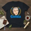 Golda Meir t-shirt with a caricature portrait surrounded by a laurel wreath and Star of David symbols, featuring the name