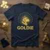 Navy t-shirt with "GOLDIE" text and a golden retriever wearing a crown graphic, surrounded by stars