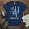 Bigfoot holding an American flag with "GONE SQUATCHIN'" text on a navy blue t-shirt