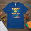 T-shirt with "GOOD VIBES BACK TO SCHOOL" text and a smiling sun graphic, books, and musical notes