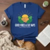 T-shirt design with "GOOD VIBES & CAT NAPS THE ULTIMATE ESCAPE" text, featuring a sleeping cat, sun, and leaves graphic