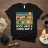 Black t-shirt with "Good Vibes & Corgi Butts" text and a cute illustration of four corgis in a grassy field