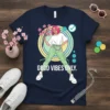 Navy blue t-shirt with "GOOD VIBES ONLY" text and a stylized illustration of a person with pink hair holding flowers