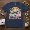 Good Vibes Only text with retro smiley flowers, rainbow, and butterflies graphic on a navy t-shirt