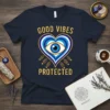 Navy t-shirt with "GOOD VIBES PROTECTED" text and a blue and white evil eye heart graphic